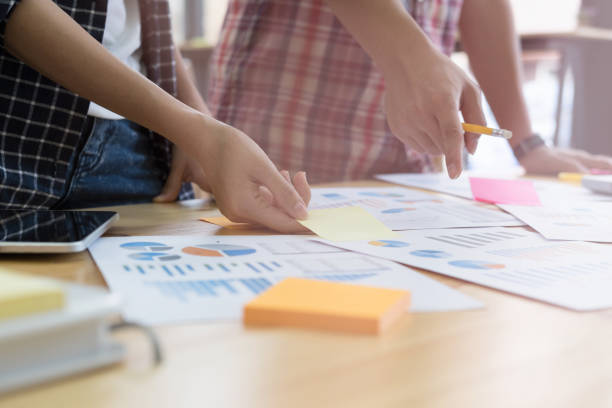 istock startup young successful team on meeting in modern office interior brainstorming, make a business plan, working on tablet with financial and marketing graph and chart 684620198