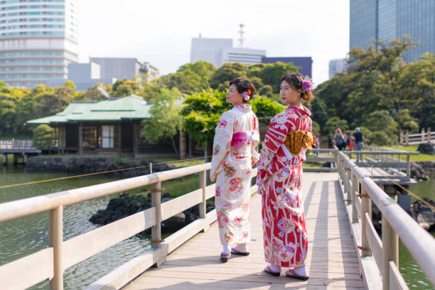istock Mother and daughter in Kimono looking over shoulder 684639994