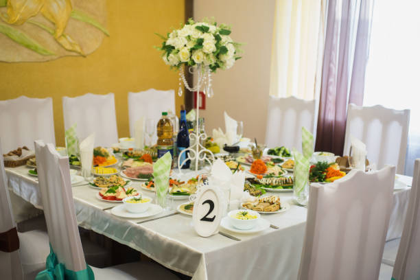 istock Decorated wedding table. Food on the table. Tableware. Empty glasses and wine glasses. Salad in a bowl. 684642796