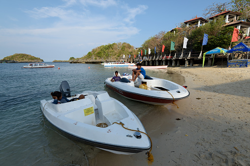 Quezon Island, Philippines - April 11, 2017: Motor boats waiting for customers on the Quezon Island in the Hundred Islands National Park in the Philippines.