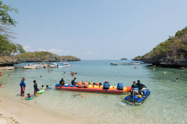 Children`s Island in the Hundred Islands National Park in the Philippines. Quezon Island, Philippines - April 12, 2017: Tourist getting ready for a banana boat ride on the Children`s Island in the Hundred Islands National Park, in the Philippines. pangasinan stock pictures, royalty-free photos & images