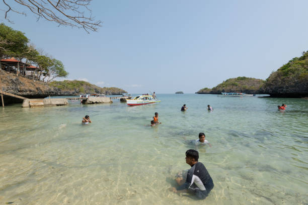 Children`s Island in the Hundred Islands National Park in the Philippines. Quezon Island, Philippines - April 12, 2017: Swimmers at the beach of the Children`s Island in the Hundred Island National Park in the Philippines. pangasinan stock pictures, royalty-free photos & images
