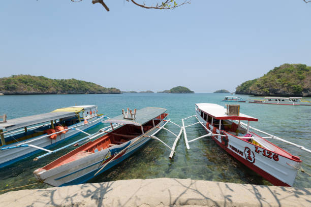 Hundred Islands National Park in the Philippines. Quezon Island, Philippines - April 12, 2017: Tourists boats at the Children`s Islands in the Hundred Islands National Park in the Philippines. pangasinan stock pictures, royalty-free photos & images