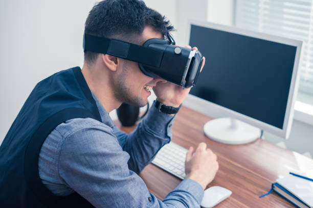 istock Young businessman putting on vr glasses and smiling 684653470