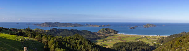 Panorama Matauri Bay and Cavalli Islands Panorama of Matauri Bay and Cavalli Islands, Northland, New Zealand on Bright Sunny Afternoon from Roadside Lookout Point northland new zealand stock pictures, royalty-free photos & images