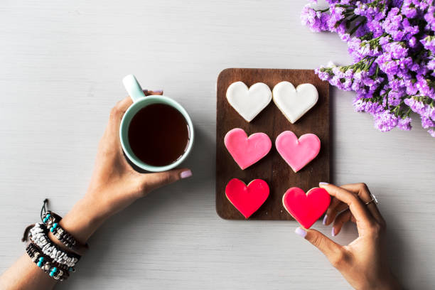 istock People Hands Showing Heart Shape Cookies with Coffee Cup 684723876