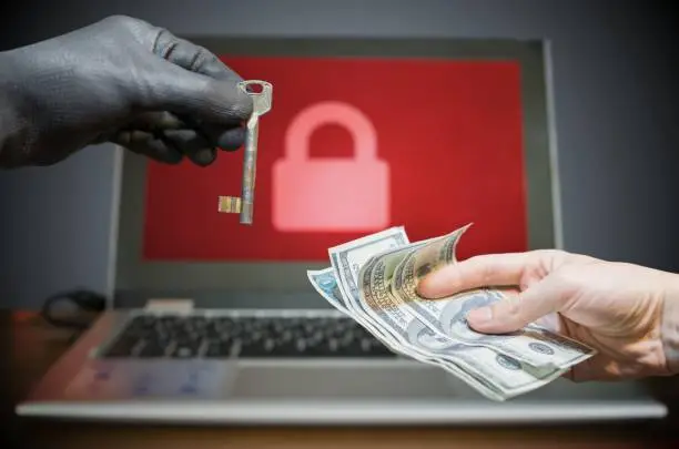 Photo of Computer security and hacking concept. Ransomware virus has encrypted data in laptop. Hacker is offering key to unlock encrypted data for money.
