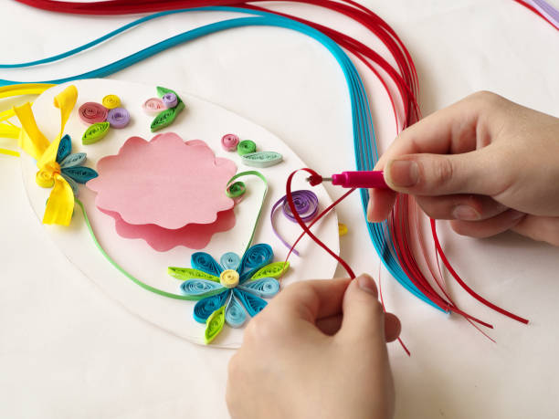 istock Decorate with strips of paper, quilling .Hands child while creative work making decorations by quilling paper 684729484