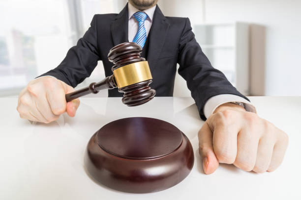 young man in suit with gavel in office. auction or justice concept. - gavel judge human hand court imagens e fotografias de stock