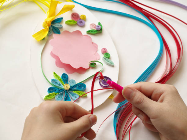 istock Decorate with stripes of paper, quilling .Hands child while creative work making decorations paper 684732286