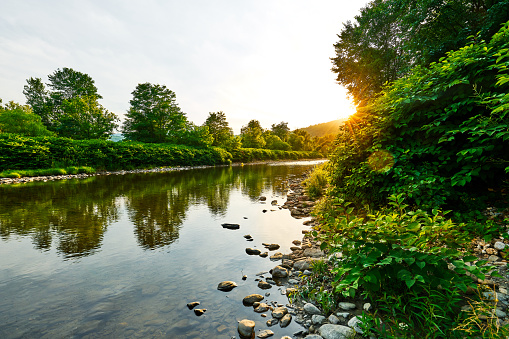 Wide shore view of Sacramento River with clouds in the background.\n\nTaken along the shore of the Sacramento River, River Bend Park, Sacramento, California, USA