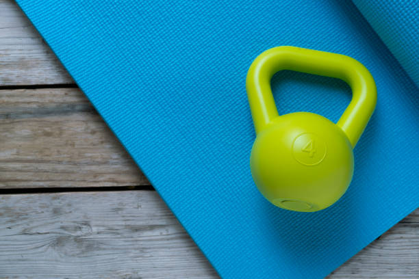 istock kettlebell and yoga mat on wood table 684744240