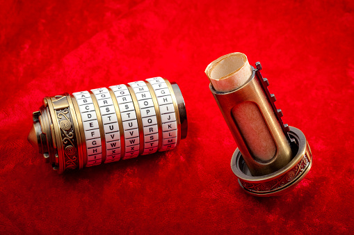 Vintage encryption and data security concept with combination puzzle box or Cryptex with secret message inside