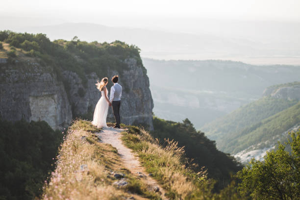 istock Wedding couple walking in the mountains with stunning views 684760754