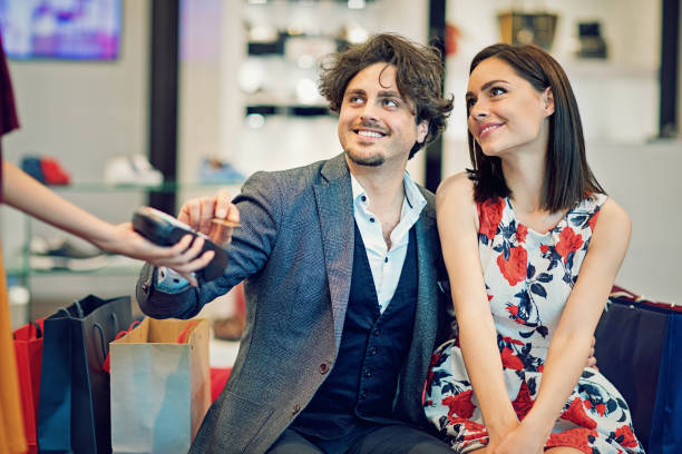istock Couple is paying using contactless credit card in the Mall 684767590