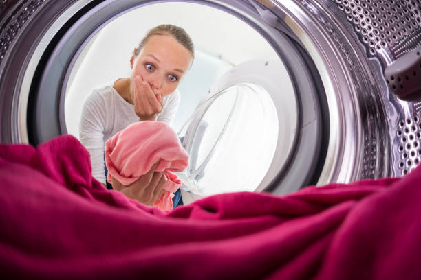 istock Young woman doing laundry - view from the washing machine 684767854