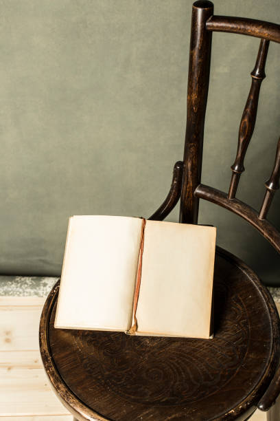 istock book on vintage chair on grey grunge background 684768134