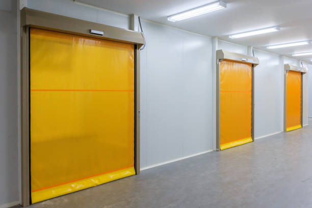 istock Roller shutter door and concrete floor inside factory building 684770442