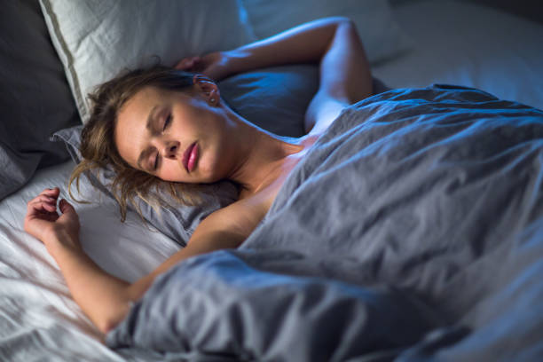 istock Beautiful young woman sleeping in bed 684774712