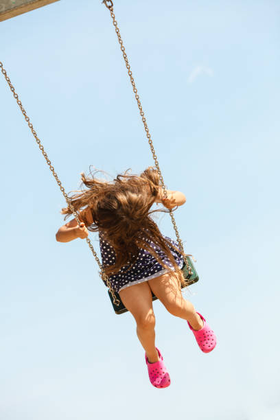 istock Girl swinging on swing-set. 684777198