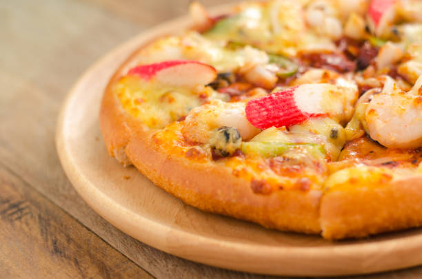 istock Pizza Seafood on wooden table ready to eat. 684787714
