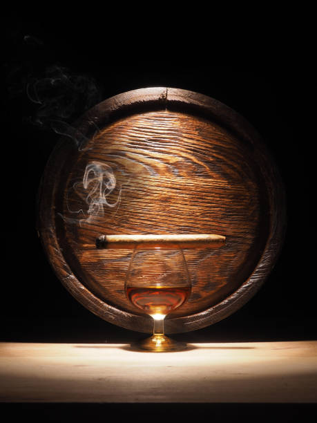 istock Glass of brandy, Cigar and old oak barrel 684793316