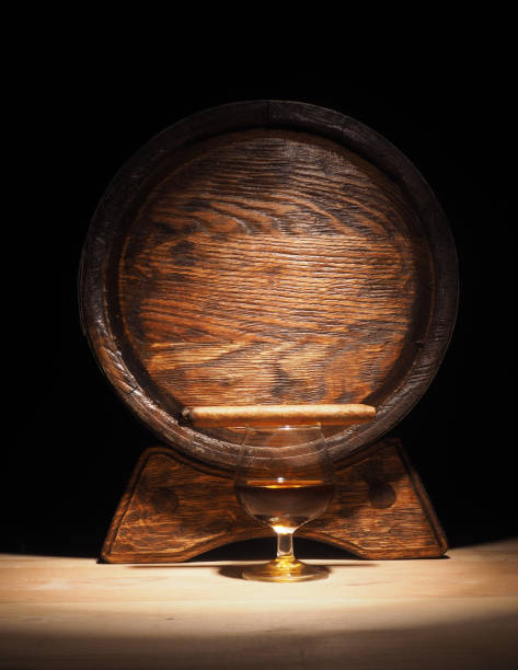 istock Glass of brandy, Cigar and old oak barrel 684793410