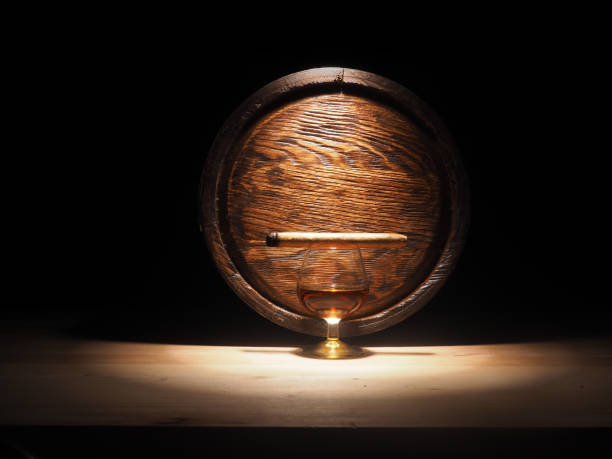 istock Glass of brandy, Cigar and old oak barrel 684793588