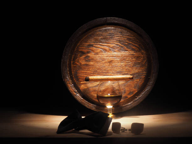istock Glass of brandy, Cigar and old oak barrel 684793874
