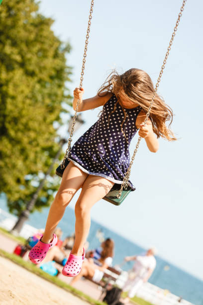 istock Girl swinging on swing-set. 684796180