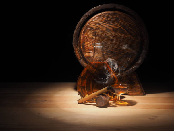 istock Glass of Cognac , Cigar and old oak barrel 684796608