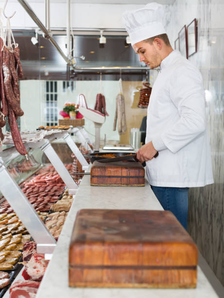 istock cheerful chief cooking fresh meat 684797078