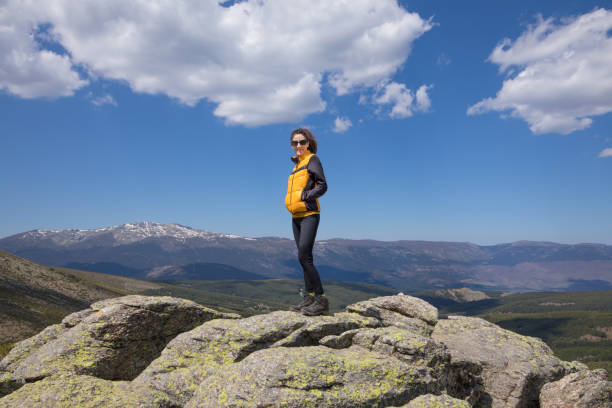 istock woman posing on rock peak in Guadarrama 684800376