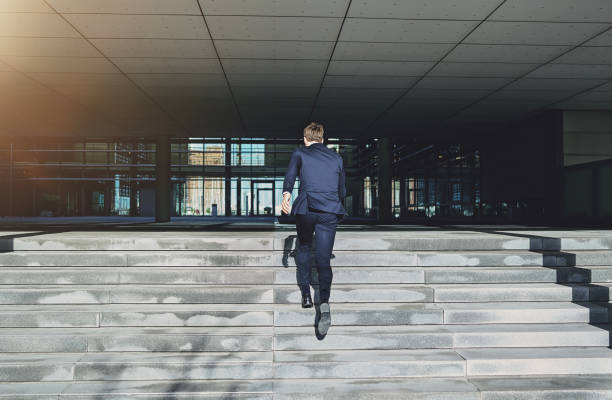 istock Runnig upstairs fast man wearing blue suit 684803340