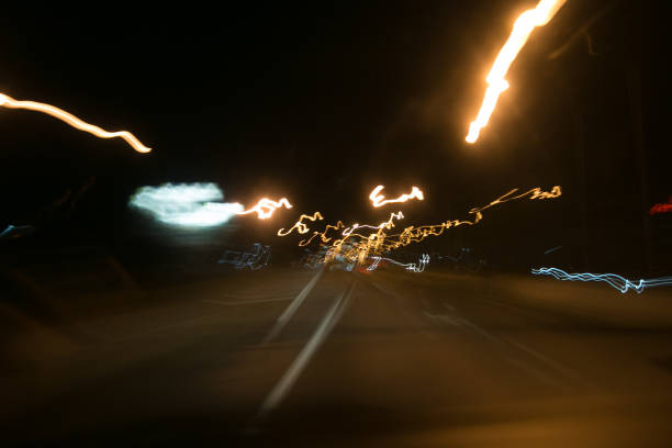 istock Street lights in speeding car in night time 684803636