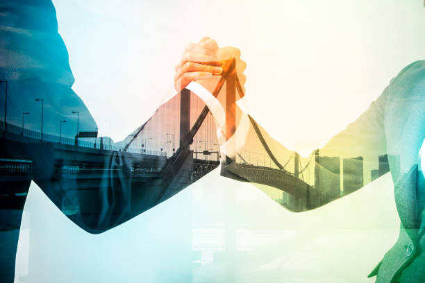 Double exposure of two business persons shaking hands and bridge skyline, relationship conceptual abstract Double exposure of two business persons shaking hands and bridge skyline, relationship conceptual abstract mediation photos stock pictures, royalty-free photos & images