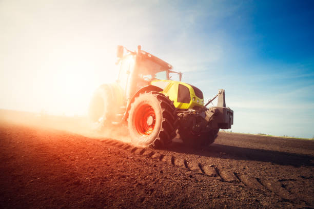 istock Tractor working on farm land on sunset 684810544