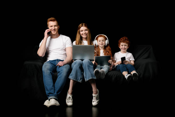 family using various digital devices - couple laptop computer digital tablet imagens e fotografias de stock