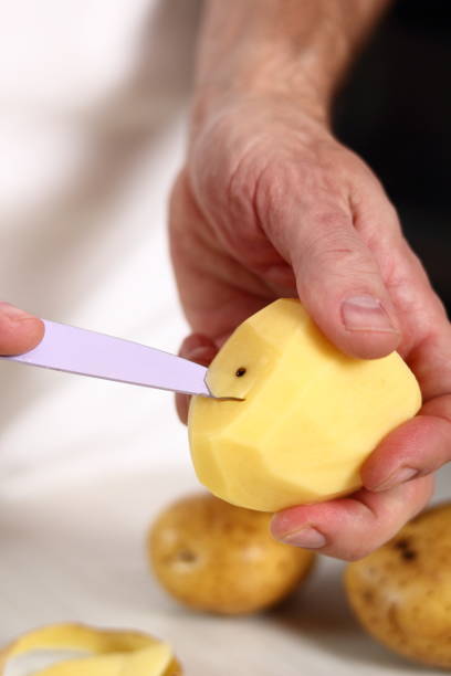 istock Removing potato eye. Making Potato and Leek Filo Pie. Series. 684817152