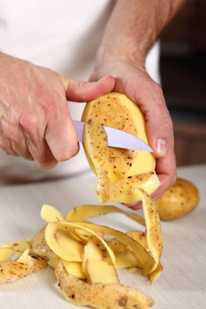 istock Peeling potato. Making Potato and Leek Filo Pie. Series. 684817210