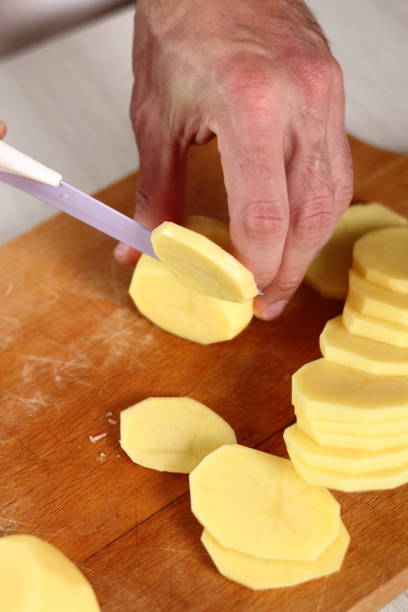 istock Slicing potato into circles. Making Potato and Leek Filo Pie. Series. 684817536