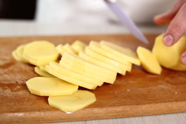 istock Slicing potato into circles. Making Potato and Leek Filo Pie. Series. 684817614