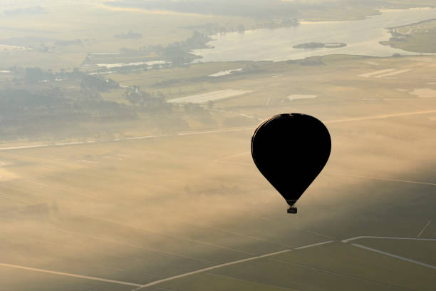 istock Hot air balloon flying in mid air during beautiful morning 684829502