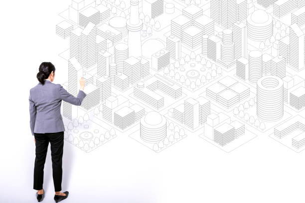 Architect drawing a residential building over an imaginary cadastral map of territory with buildings, fields and roads