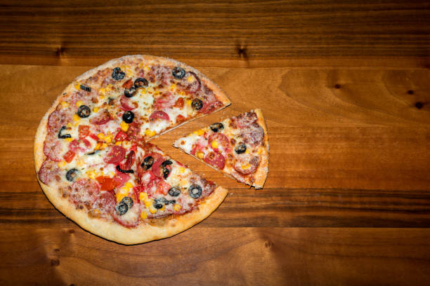 istock Delicious pizza and wooden background 684829988