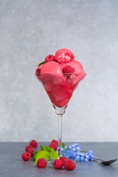 istock Raspberry ice cream sorbet in glass with raspberry, mint leaves  copy space on grey textured background 684830462