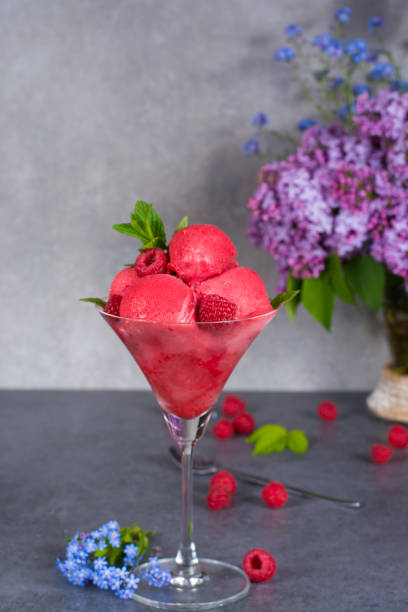 istock Raspberry ice cream sorbet in glass with raspberry, mint leaves  copy space on grey textured background 684830562