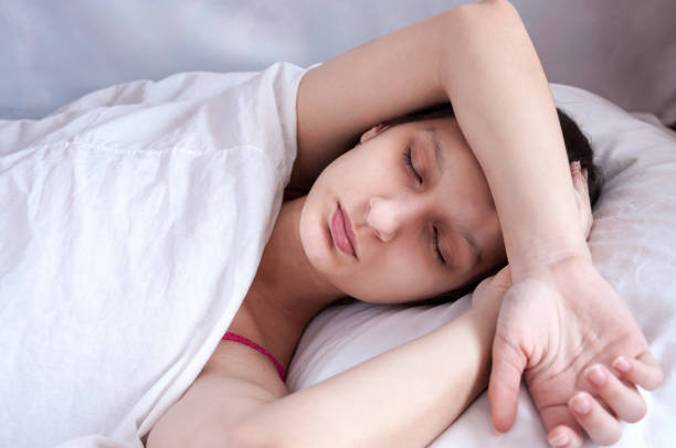 istock Girl brunette sleeping in her bed on white pillow 684832886