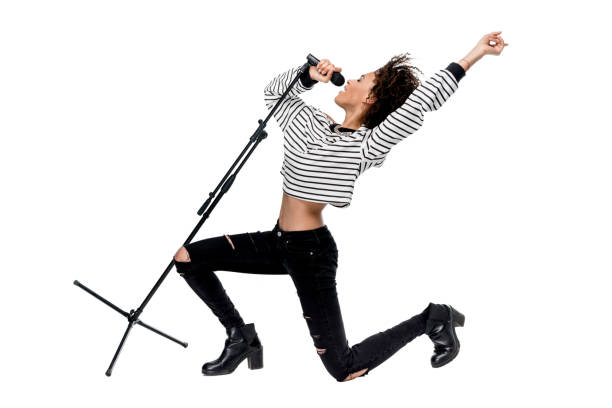 istock Beautiful young emotional heavy metal singer with microphone singing isolated on white 684833362