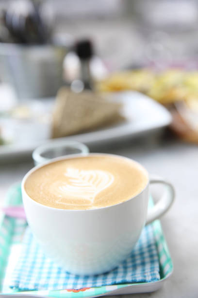istock cappuccino coffee on wood background 684833540